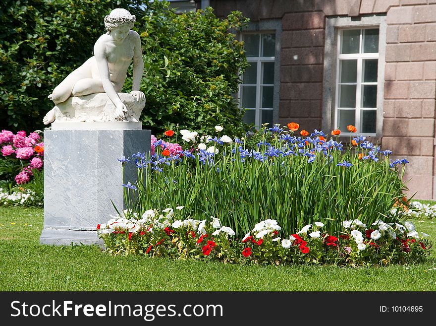 Statue of a girl in a summer garden