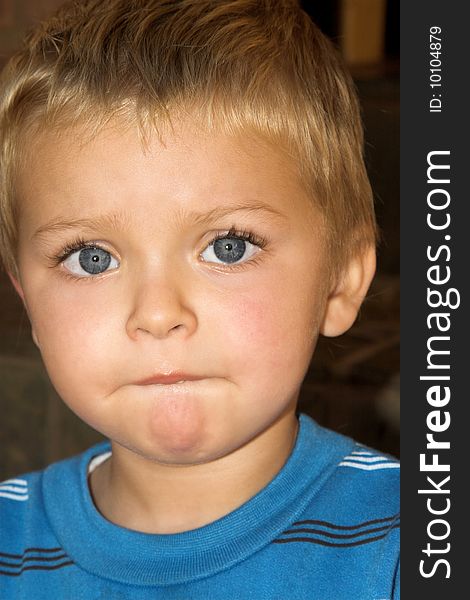 Young boy with beautiful blue eyes, serious expression