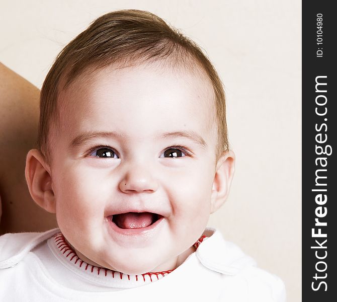 Beautiful brunette baby girl with cute facial expressions