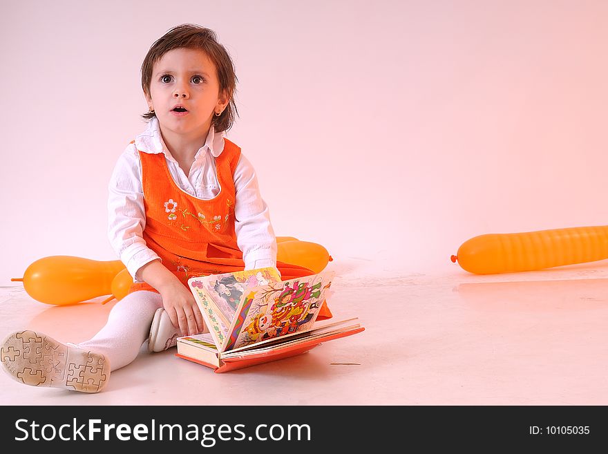 Cute girl with book for children and orange ballons. Cute girl with book for children and orange ballons