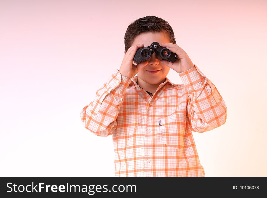 Cute boy with black binoculars looking around. Cute boy with black binoculars looking around