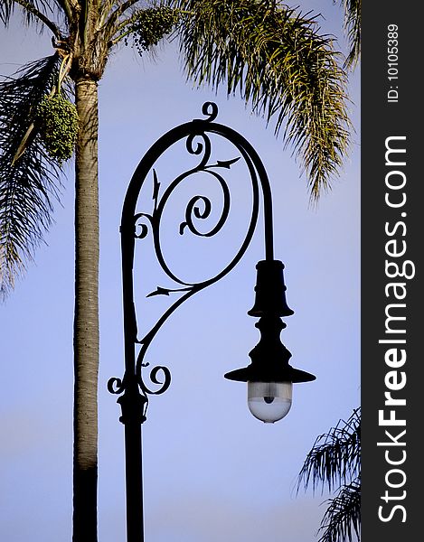 Ornate wrought iron street light in the early evening