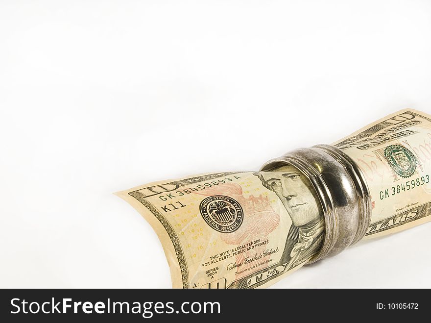 A rolled up ten US dollar bill in a silver napkin ring