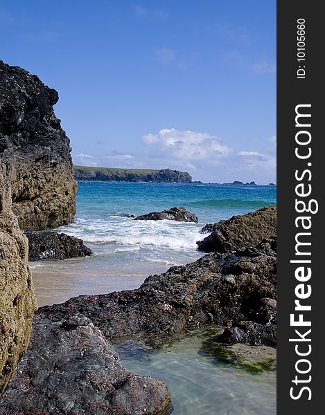 Rockpool and beach at Kynance Cove in Cornwall