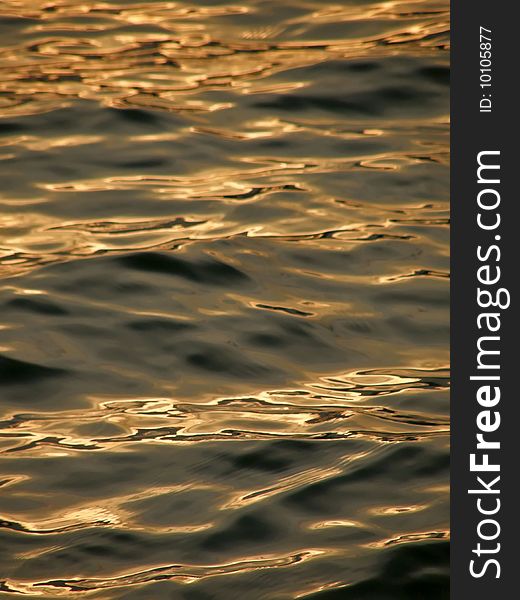 Beautiful reflection of sun light in the sunset on Adriatic sea. Vertical color photo. . Beautiful reflection of sun light in the sunset on Adriatic sea. Vertical color photo.