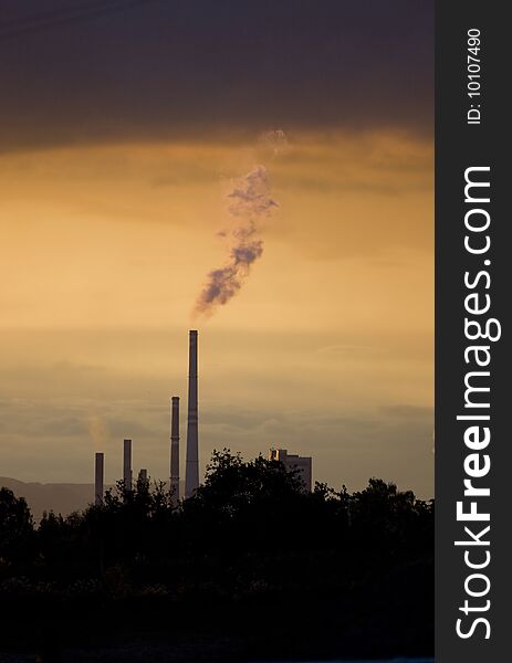 Power plant in sunset, smoking, ecology