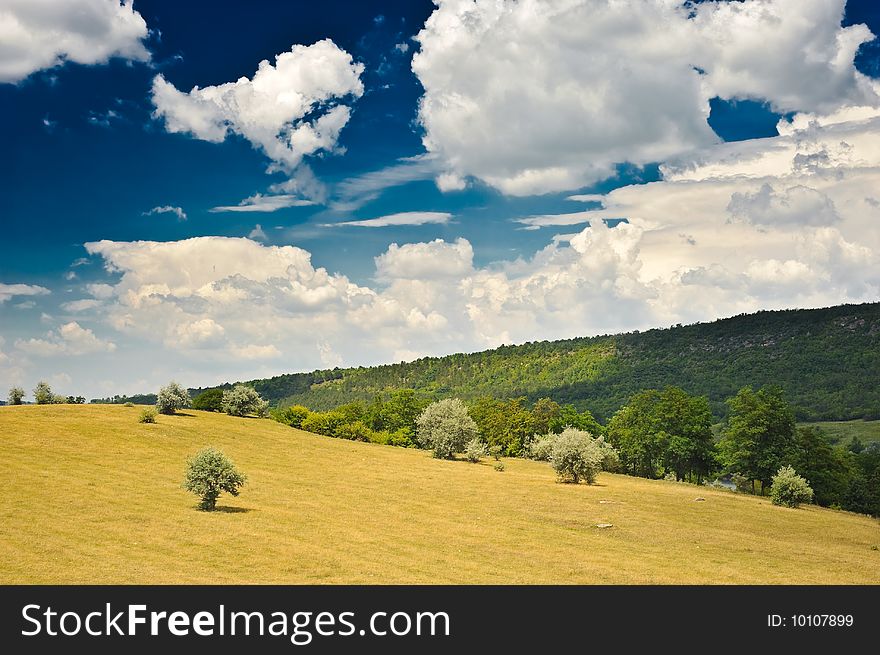 Rural landscape with blue sky and clouds on it