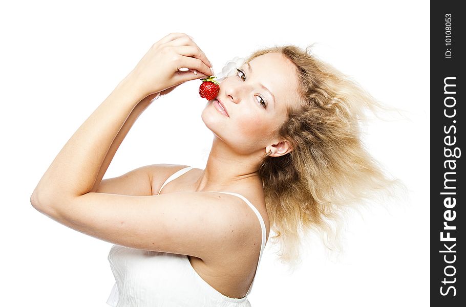 Young woman in white dress eating strawberries