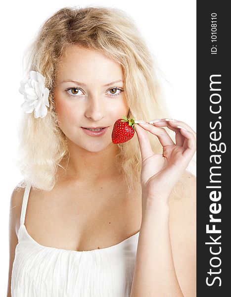 Young woman in white dress eating strawberries. Isolated on white background