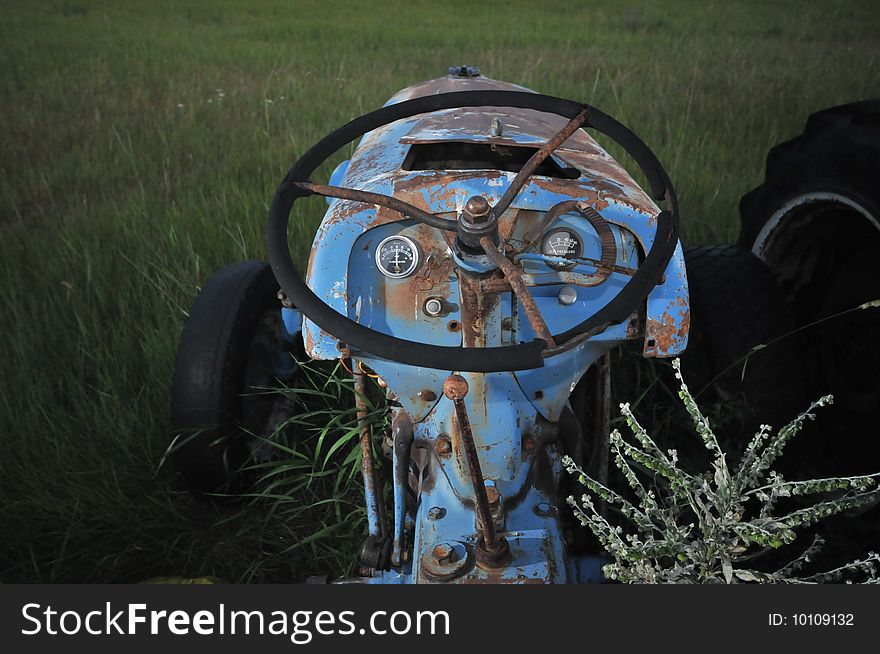 Tractor in a field with weeds. Tractor in a field with weeds