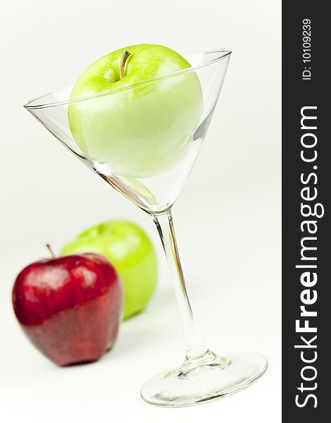 A Martini glass with an apple inside. A Martini glass with an apple inside