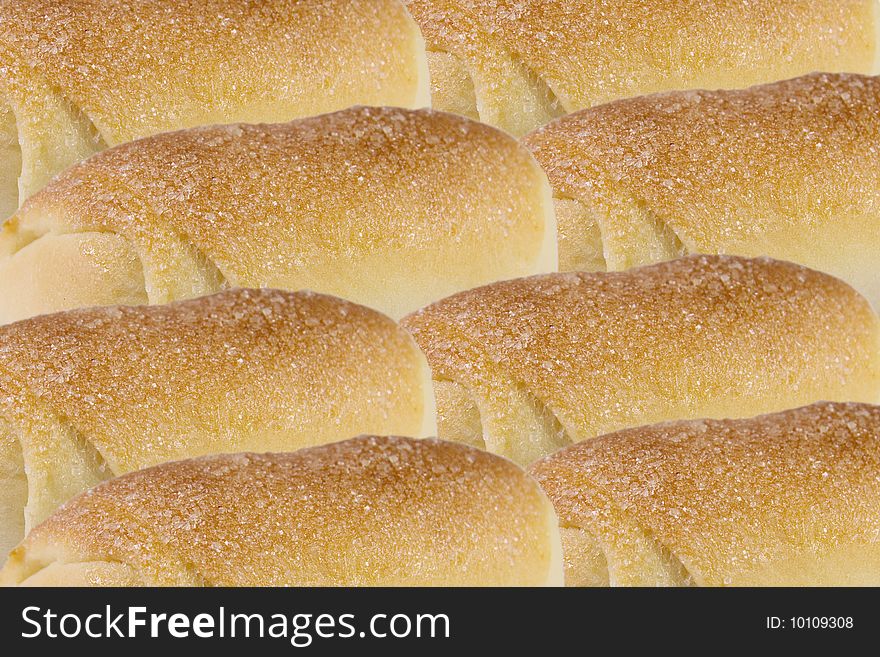 Rows of rolls with sugar (as a food background)