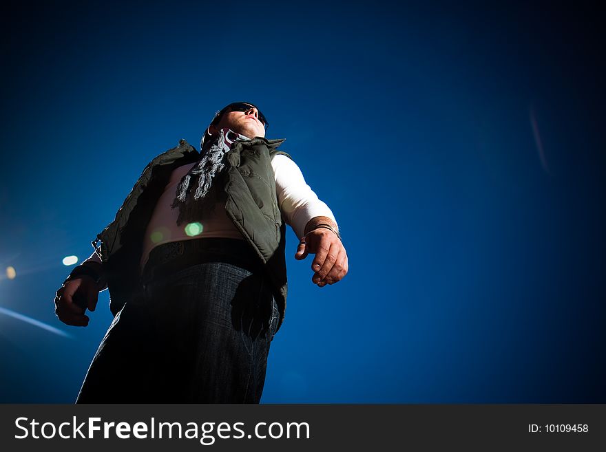 Young fashion model in jeans shot outdoors on a blue sky