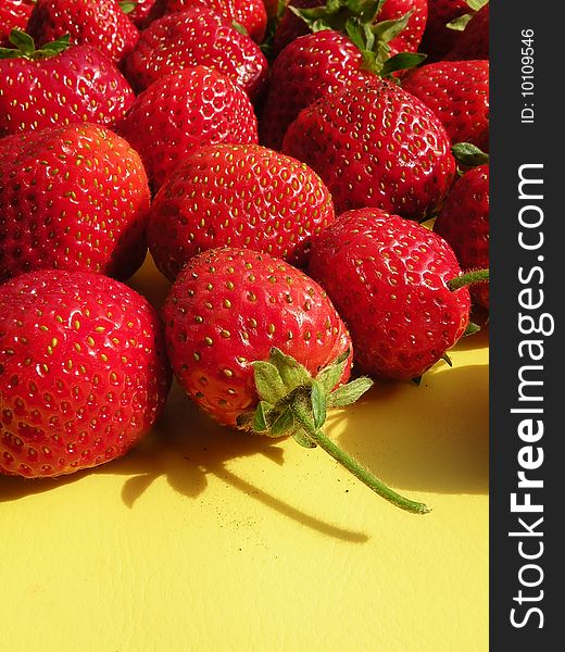 Fresh Strawberries on the yellow background