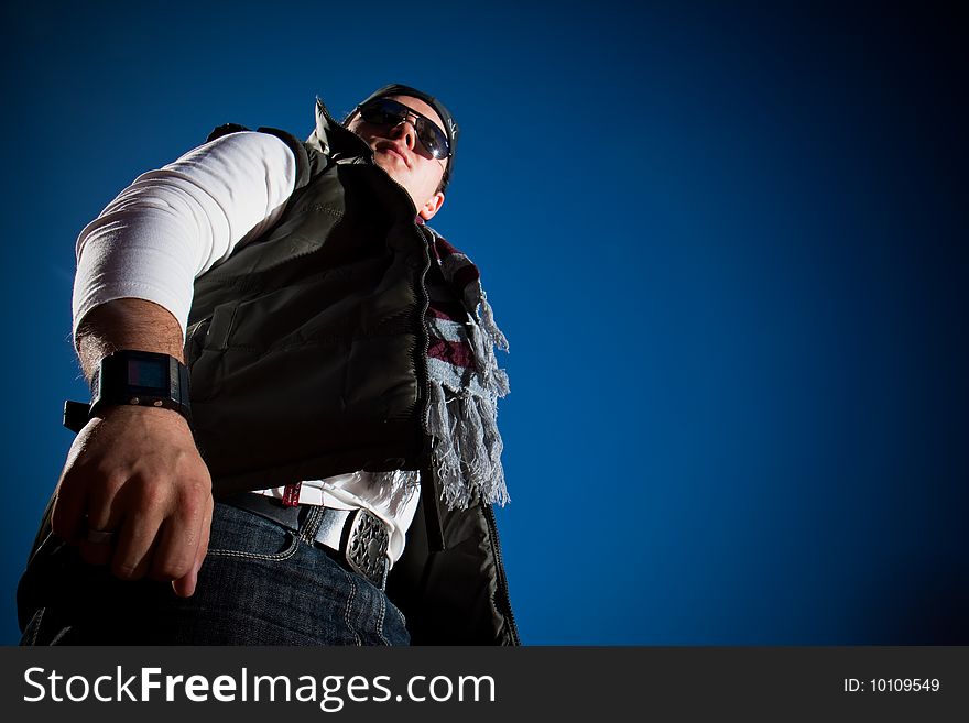 Young fashion model in jeans shot outdoors on a blue sky