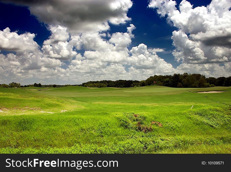 Beautiful clouds with blue sky background over a piece of land. Beautiful clouds with blue sky background over a piece of land