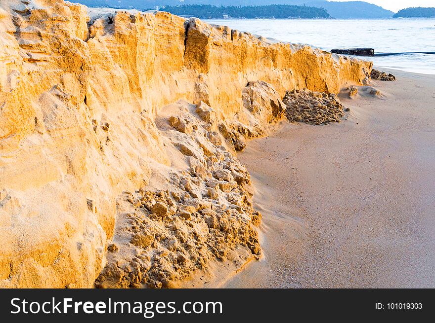Sand texture of the colored sand cliffs on beach