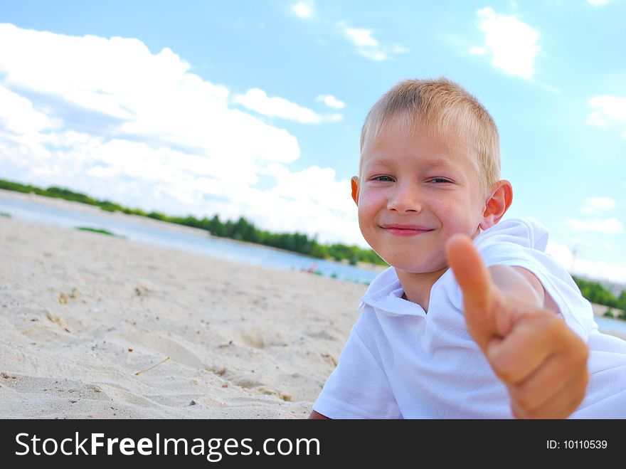 Portrait of little boy showing thumbs up sign