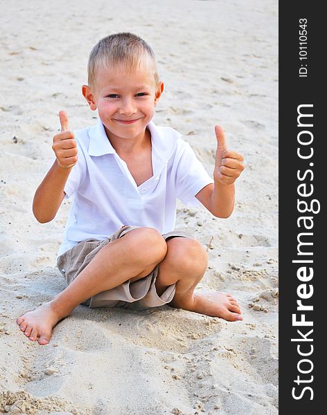 Little boy showing thumbs up sign