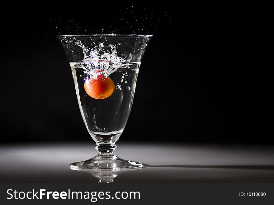 Cherry Tomato dropped into a glass of water