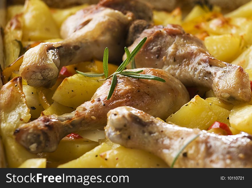 Roasted chicken with potatoes and rosemary close up