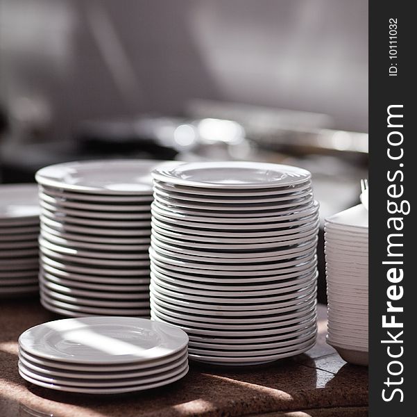 Piles of white pure plates on a table