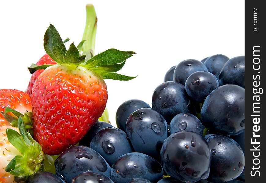 Fresh ripe strawberries and grapes isolated on white background. Fresh ripe strawberries and grapes isolated on white background