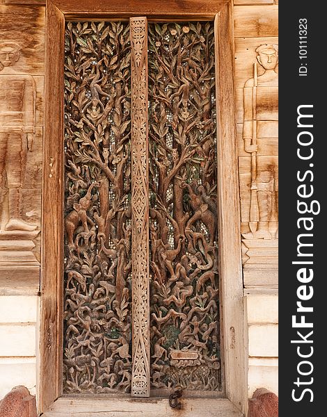 Door of teak wood church, Wat Kut Ti, Petchaburi province, Thailand. Door of teak wood church, Wat Kut Ti, Petchaburi province, Thailand