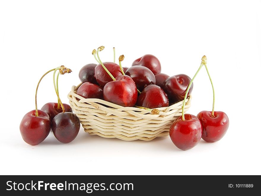 A few cherryes in the basket on white background