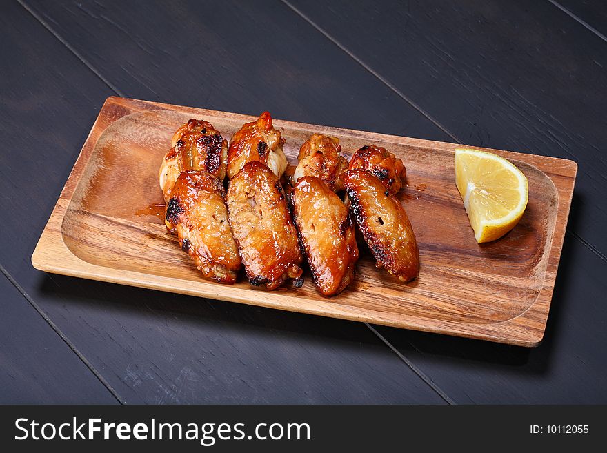 Grilled chicken wings served on wooden board