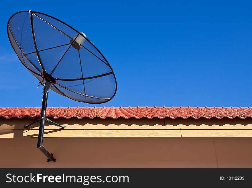Blue sky and satellite dish on roof. Blue sky and satellite dish on roof