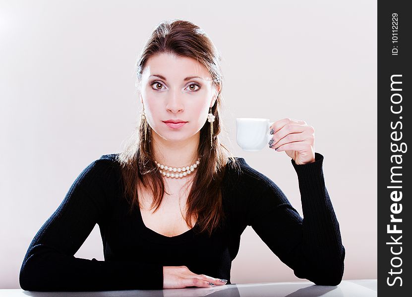 Pretty girl holding a cup