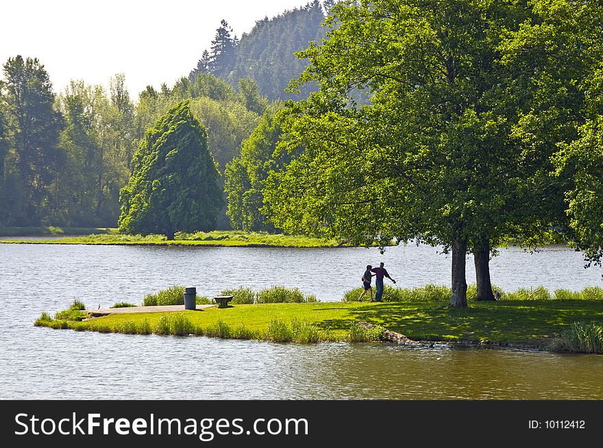 Couple walking by the lake in the park