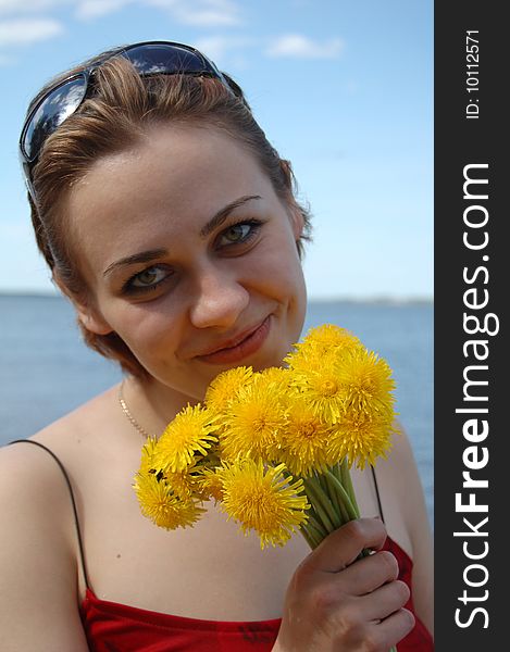 Attractive girl holding yellow flowers