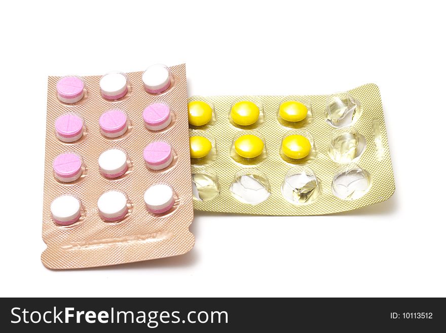 Pink and yellow pills in blister packs