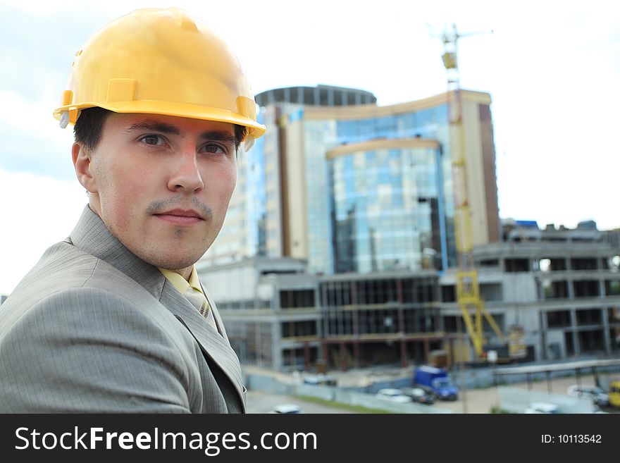Industrial theme: constructor standing at a site area. Industrial theme: constructor standing at a site area.