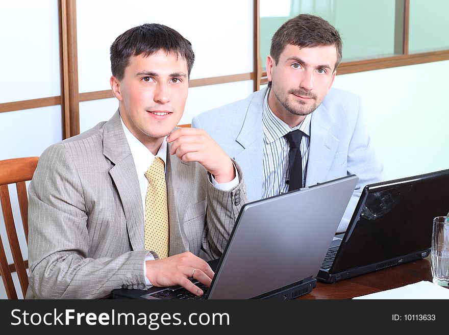 Business theme: business people in a work process in office. Business theme: business people in a work process in office.