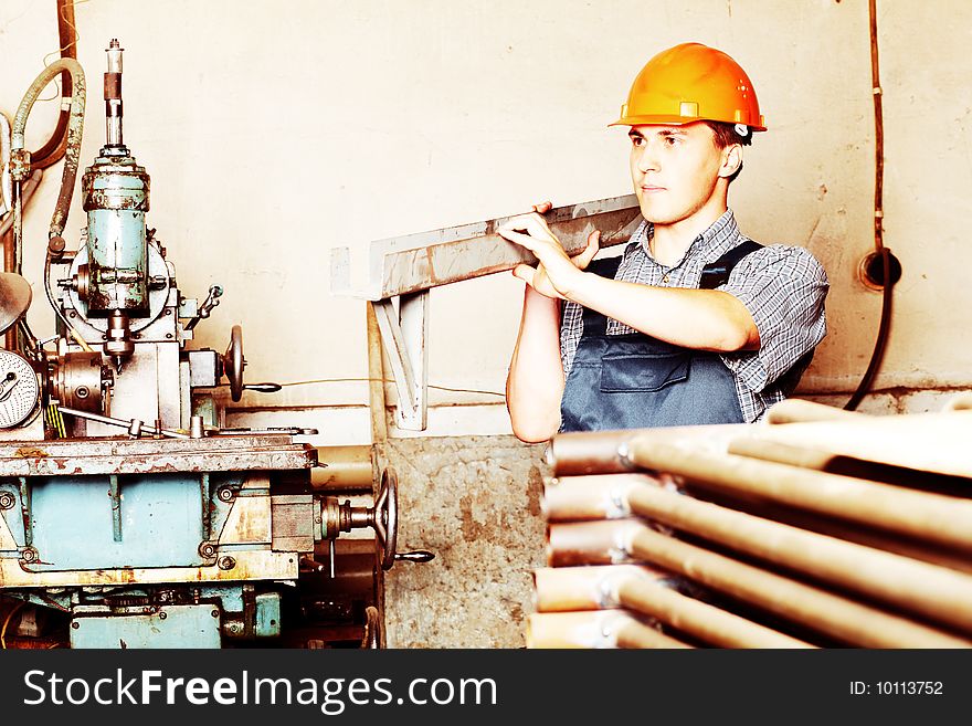 Industrial theme: a worker at a manufacturing area. Industrial theme: a worker at a manufacturing area.