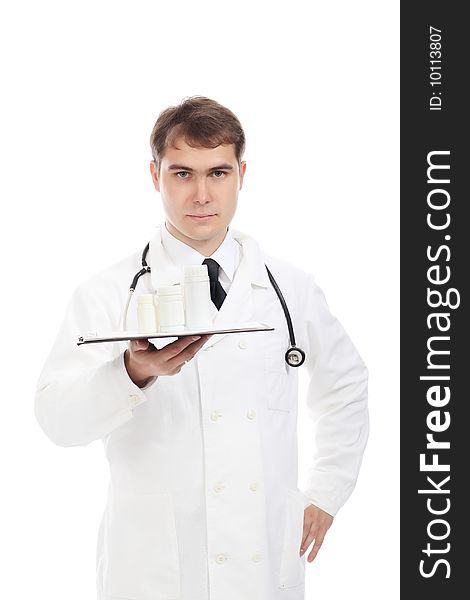 Medical theme: serious doctor holding pills.