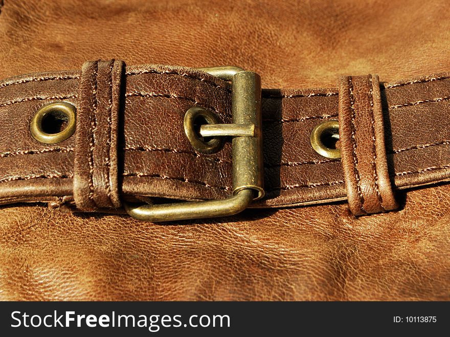 Brown leather with belt fastener (texture, material, background, decoration)