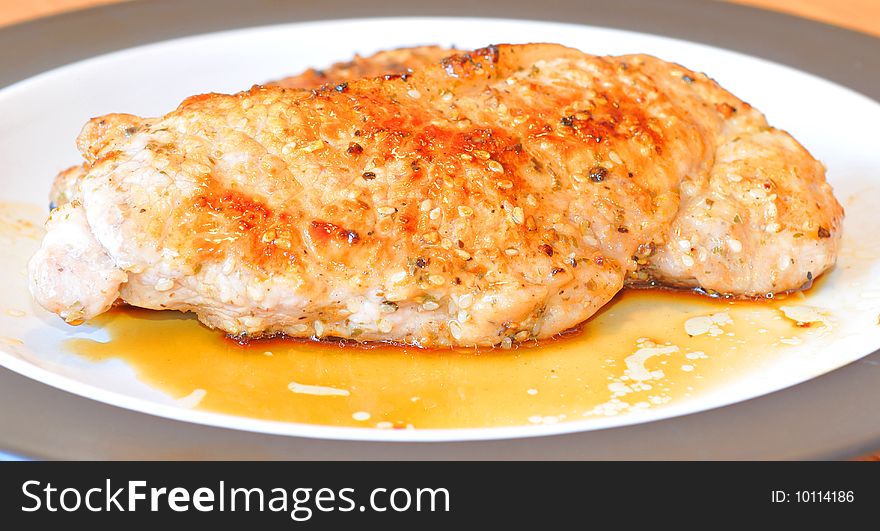 An image of a plate of cooked pork chop.