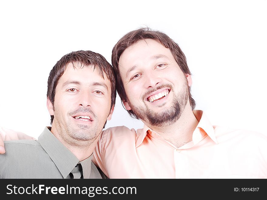 Two men in shirts are smiling and huging each other. Two men in shirts are smiling and huging each other