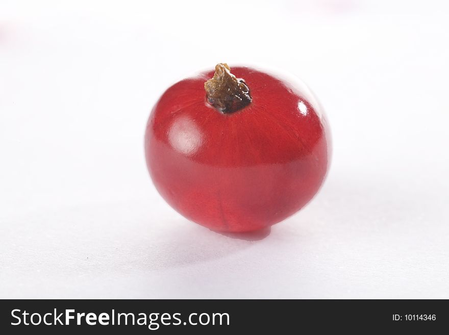 Extreme close up of a red currant on a white background isolated.