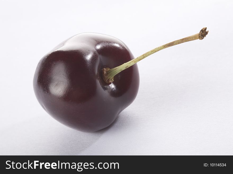 Close up of a cherry on a white background isolated.