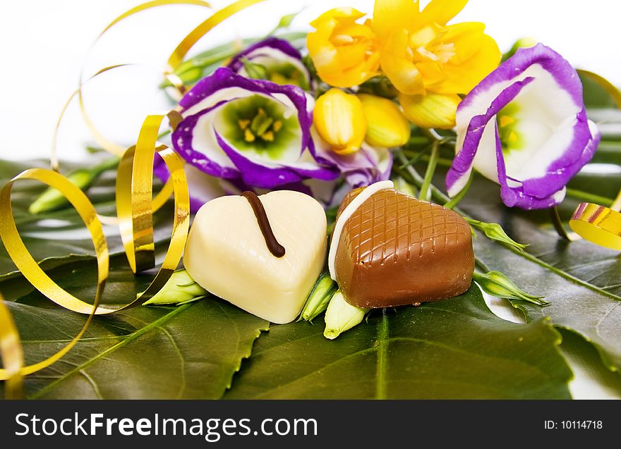 Celebration of a special day with luxury heart shaped chocolates, golden ribbons, and fresh flowers. This image is exclusive to DT. Celebration of a special day with luxury heart shaped chocolates, golden ribbons, and fresh flowers. This image is exclusive to DT.