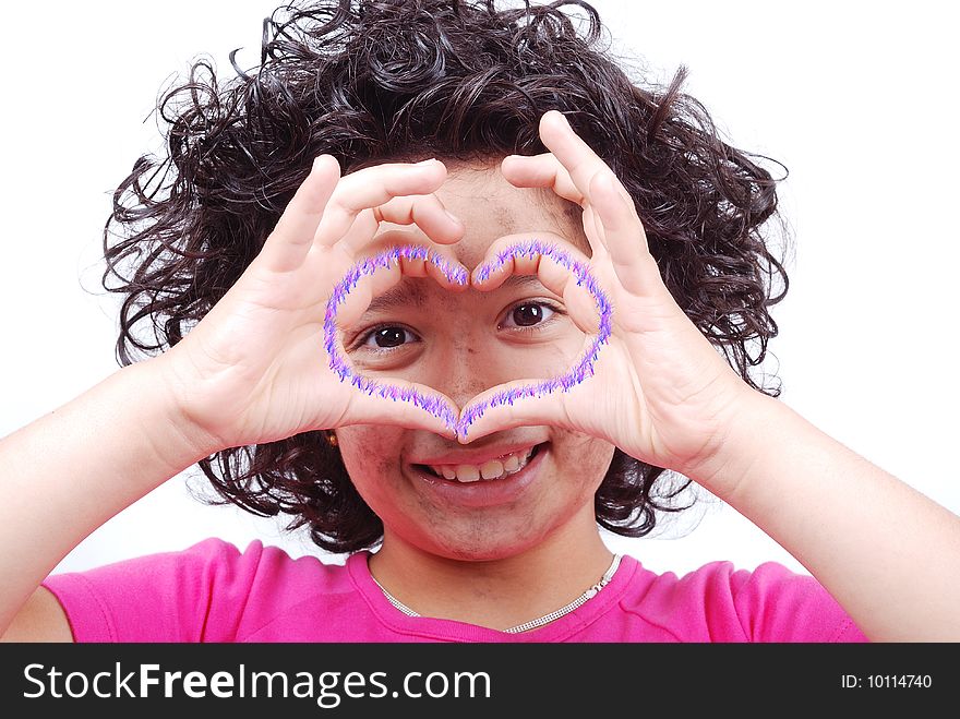 A little girl with heart shaped hands looking through