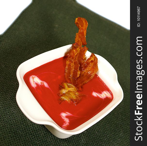 Creamy red beet soup with bacon decoration