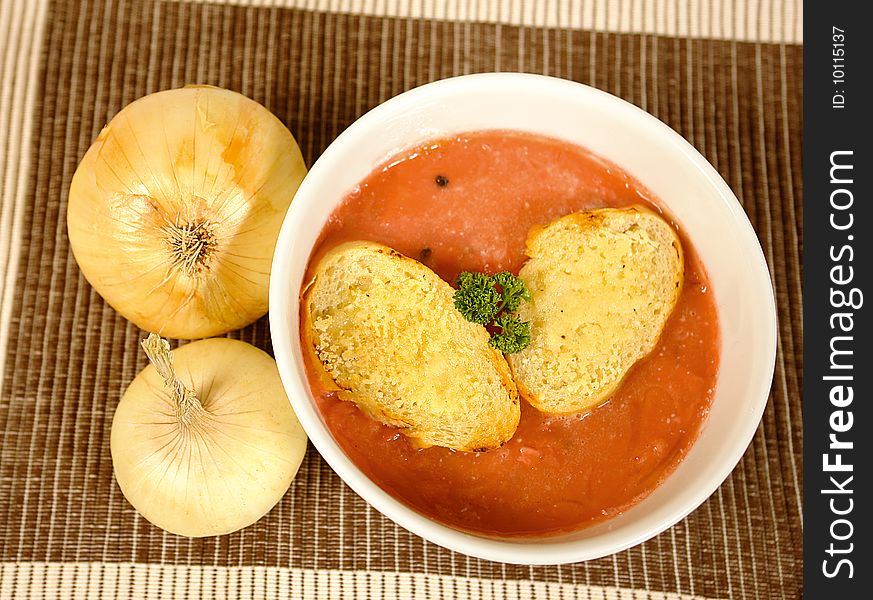 Onion and tomato soup with baguette bread. Onion and tomato soup with baguette bread