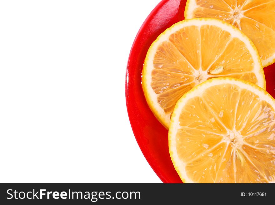 Three slice of orange on a red plate isolated on white