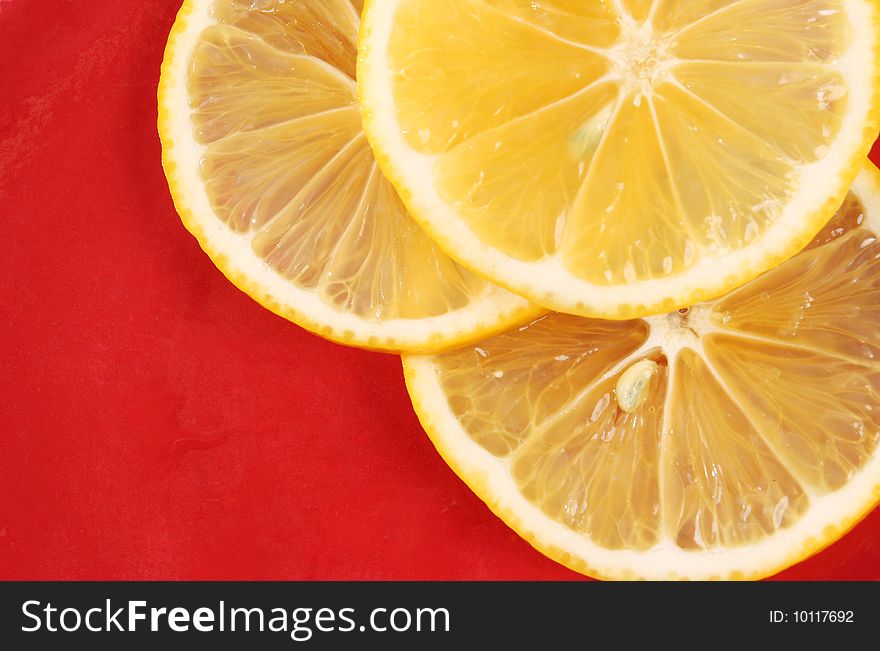 Three slice of orange on a red background